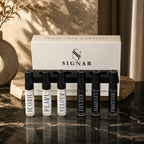 SIGNAR Discovery Set featuring six 5ml Extrait De Parfum tester vials displayed on dark marble countertop.