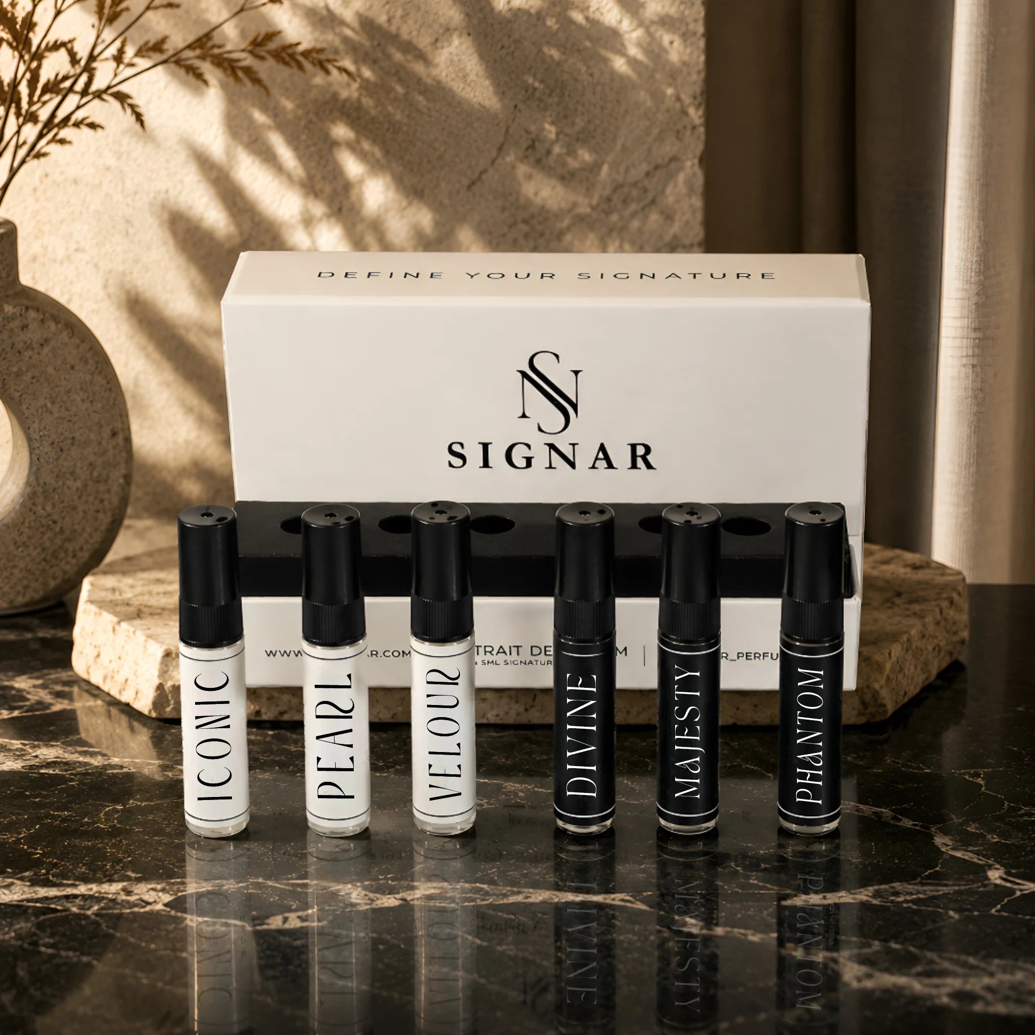 SIGNAR Discovery Set featuring six 5ml Extrait De Parfum tester vials displayed on dark marble countertop.