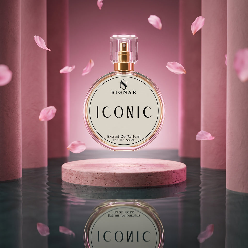SIGNAR ICONIC Extrait De Parfum perfume bottle displayed on a round pedestal, surrounded by floating pink petals against a pink cylindrical studio backdrop.