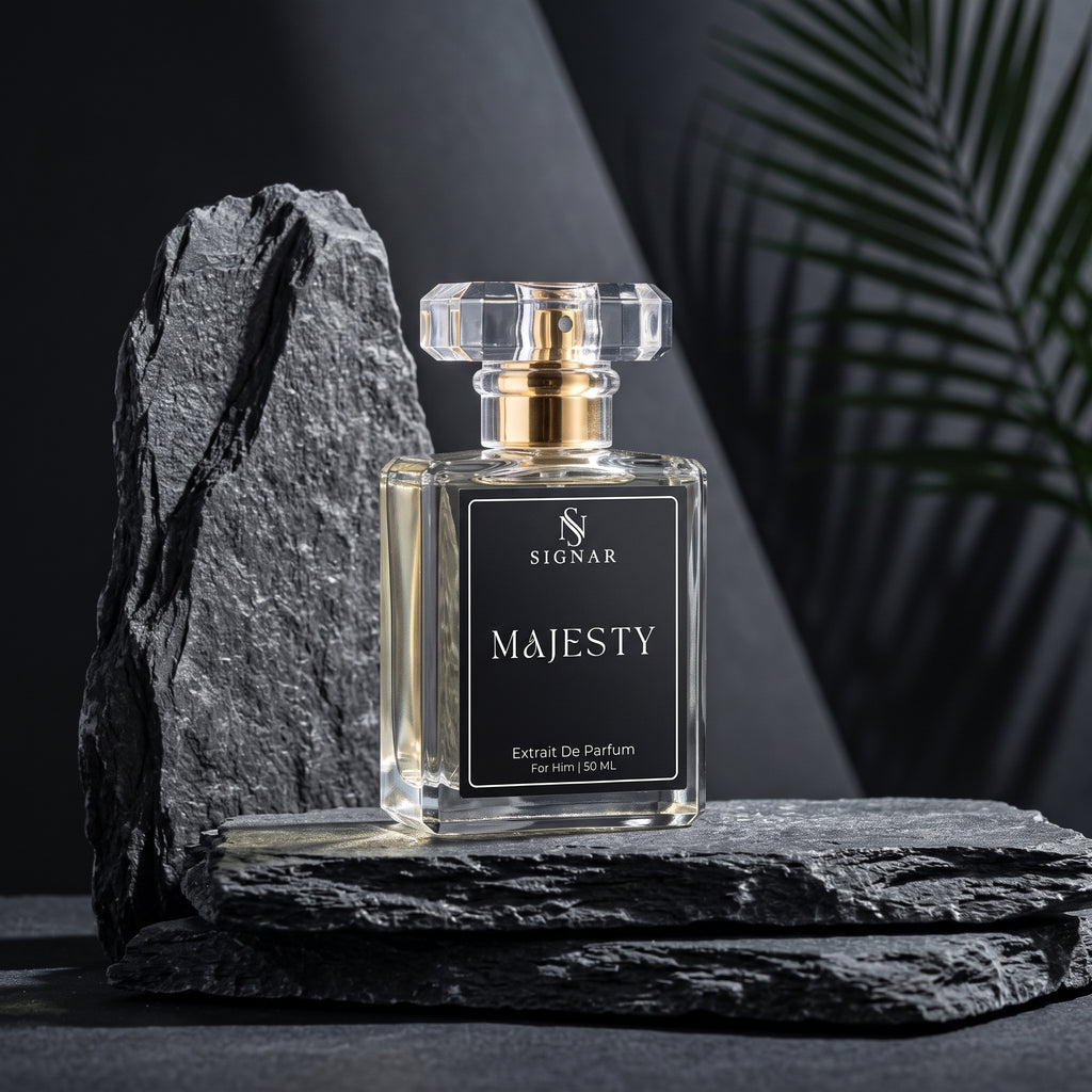 SIGNAR MAJESTY Eau de Parfum in a clear glass bottle with a black label and gold cap, styled on dark slate rocks with a dark background and a palm leaf.