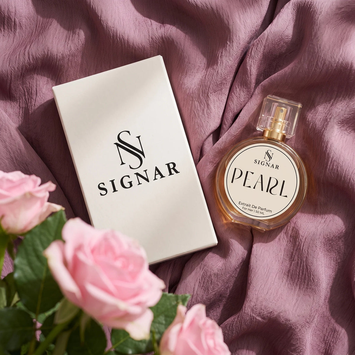 SIGNAR Pearl Extrait de Parfum perfume bottle next to its white box, styled on a draped dusty purple fabric with pink roses in the foreground.
